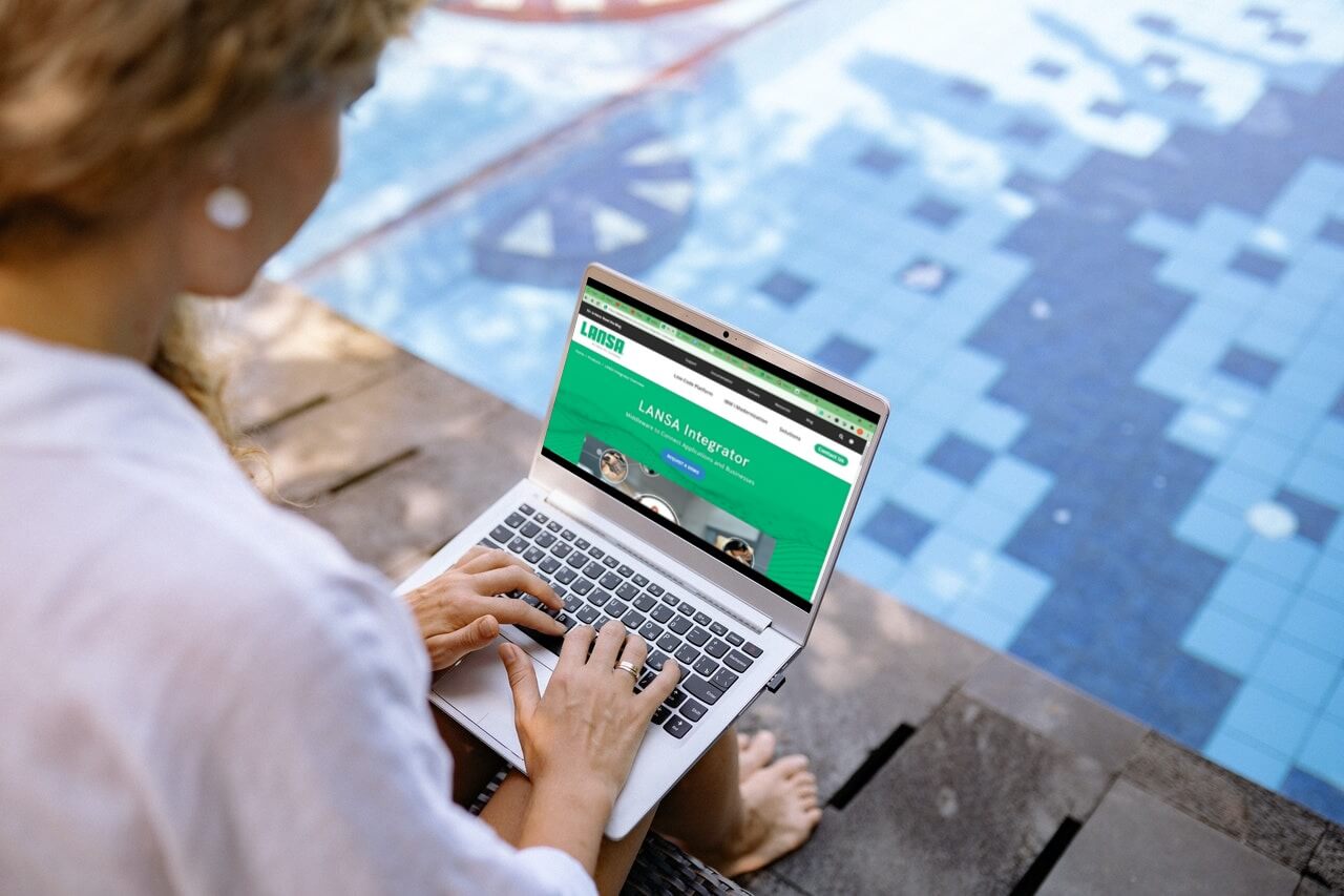 Female working On Laptop sitting near Swimming pool